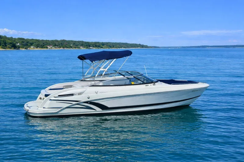 The Image of 2015 Formula 240 Bowrider boat with canopy on calm blue water. - 0
