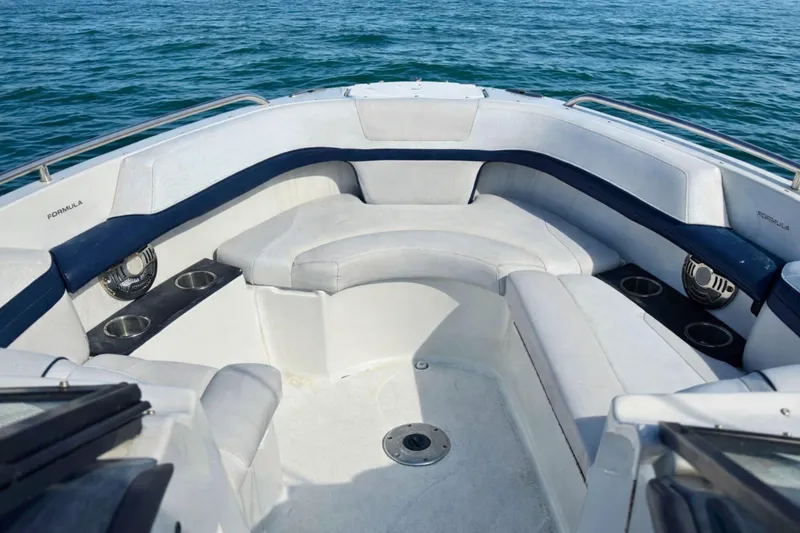 Slide: The Image of 2015 Formula 240 Bowrider interior seating with white and navy upholstery. - 13