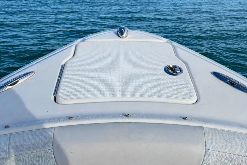 Slide: The Image of 2015 Formula 240 Bowrider interior with white and blue seating, cup holders, and speaker. - 17