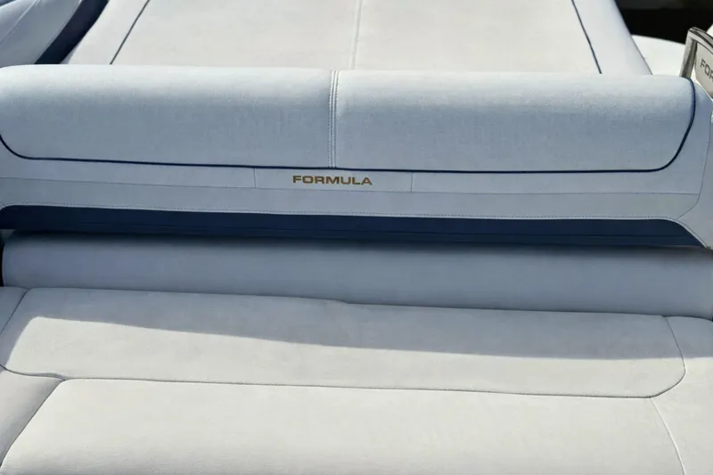 Slide: The Image of 2015 Formula 240 Bowrider interior seating with speaker, featuring white and navy upholstery. - 5