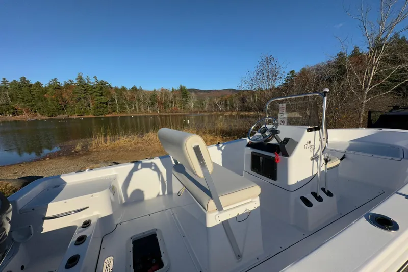 Slide: The Image of 2017 Sportsman Island Reef 17 Center Console boat by a serene lake. - 3