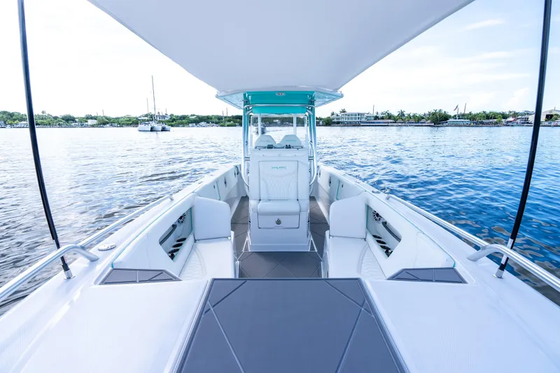 Slide: The Image of 2024 Dynamic D-305V boat interior with sleek seating, overlooking calm waters and distant shoreline. - 11