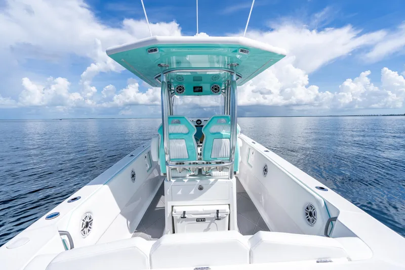 Slide: The Image of 2024 Dynamic D-305V boat on calm ocean under blue sky with clouds. - 15
