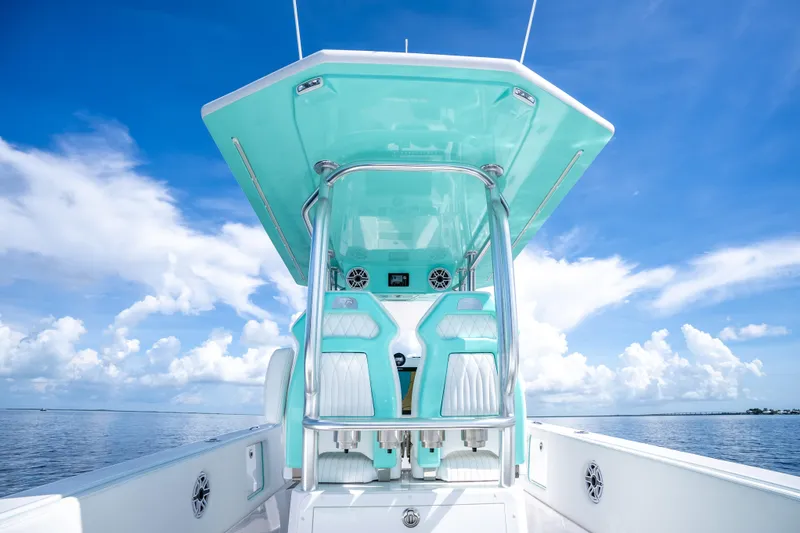 Slide: The Image of 2024 Dynamic D-305V boat interior with turquoise accents under a clear blue sky. - 16