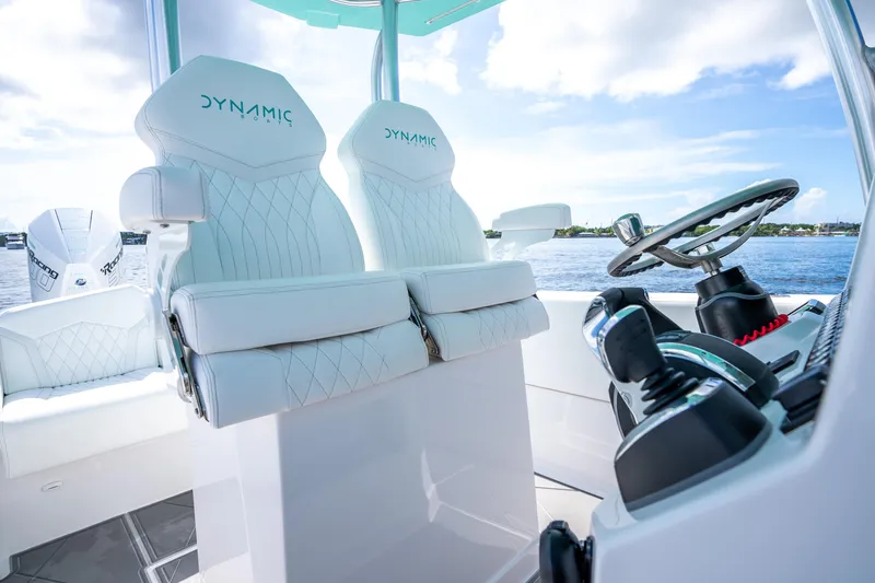 Slide: The Image of 2024 Dynamic D-305V boat interior with white leather seats and modern steering controls. - 17