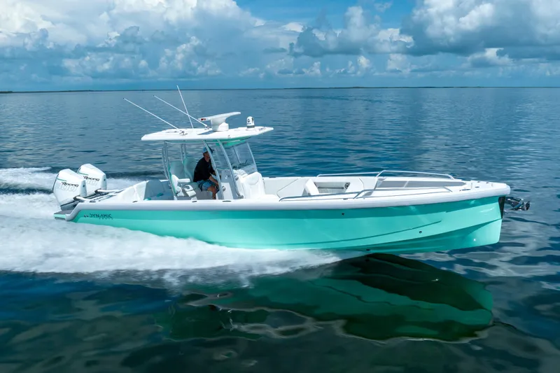 Slide: The Image of 2024 Dynamic D-305V boat cruising on calm ocean waters under a cloudy sky. - 2