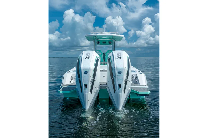 Slide: The Image of 2024 Dynamic D-305V boat with dual engines on calm water under cloudy sky. - 7