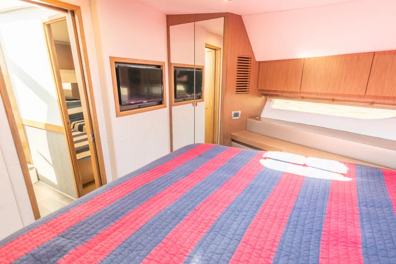 Slide: The Image of Luxurious 2017 Sea Ray Fly 510 yacht bedroom with striped bedding and modern decor. - 60