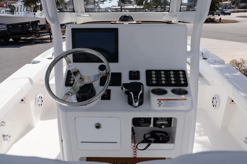 Slide: The Image of 2026 Caymas 24 HB boat console with steering wheel, controls, and display screen. - 12