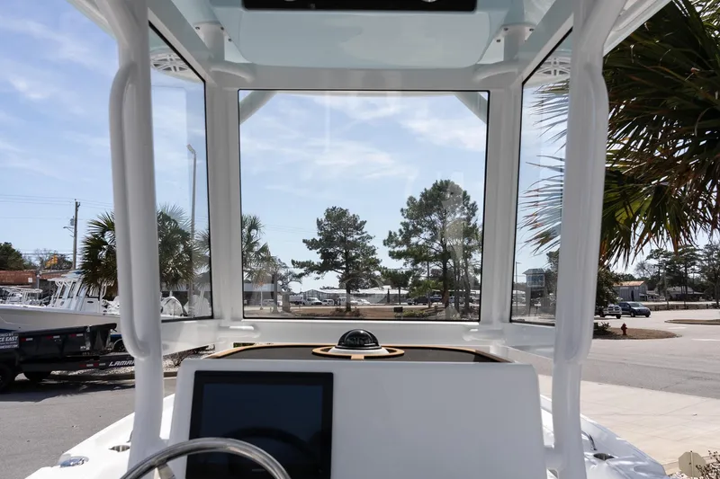 Slide: The Image of 2026 Caymas 24 HB boat interior with clear windshield and modern dashboard. - 13