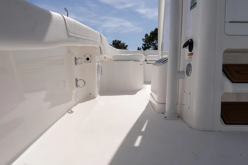 Slide: The Image of 2026 Caymas 24 HB boat interior, showcasing sleek white deck and modern design features. - 15