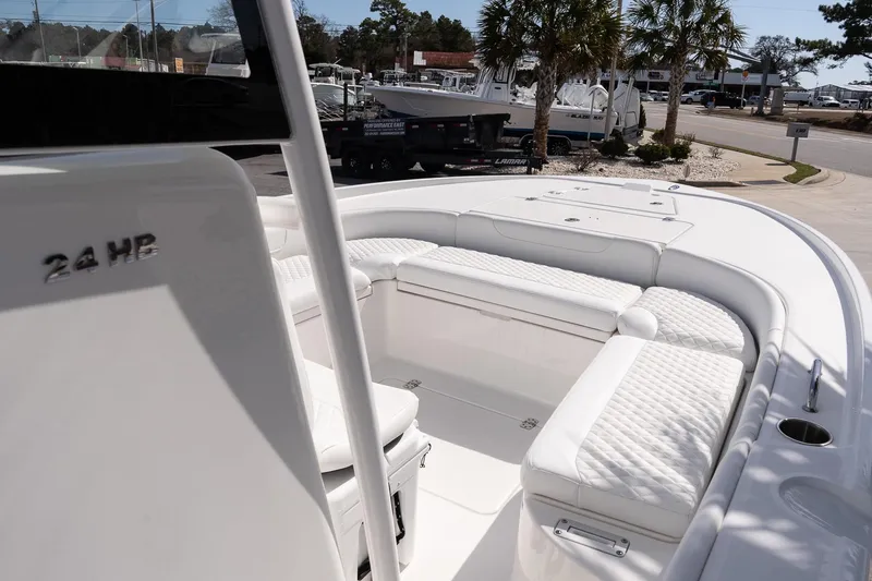 Slide: The Image of 2026 Caymas 24 HB boat interior with white cushioned seating and sleek design. - 18