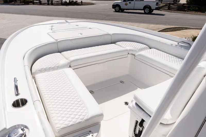 Slide: The Image of 2026 Caymas 24 HB boat interior with white quilted seating and spacious deck. - 19