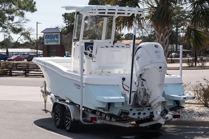 Slide: The Image of 2026 Caymas 24 HB boat with Yamaha 300 engine, parked near Neuse Sport Shop. - 3