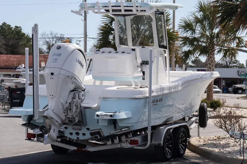 Slide: The Image of 2026 Caymas 24 HB boat on trailer, featuring Yamaha V6 engine, parked outdoors. - 5
