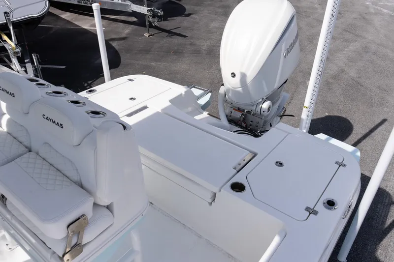 Slide: The Image of 2026 Caymas 24 HB boat with Yamaha outboard engine, featuring cushioned seating and storage compartments. - 8