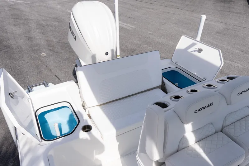 Slide: The Image of 2026 Caymas 24 HB boat interior with Yamaha engine, featuring seating and storage compartments. - 9