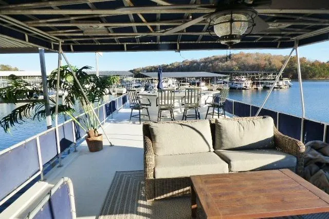 Slide: The Image of Houseboat deck with seating, dining area, and scenic lake view; Starlite 15x67, 2001 model. - 13