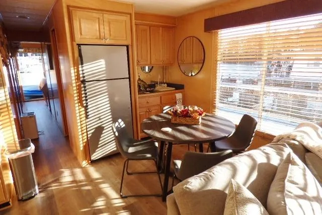 Slide: The Image of Cozy interior of 2001 Starlite 15x67 houseboat with dining area and kitchen. - 5