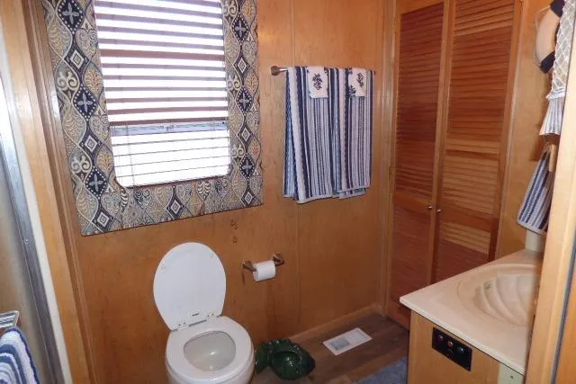 Slide: The Image of Bathroom interior of 2001 Starlite 15x67 with wooden accents and striped towels. - 9