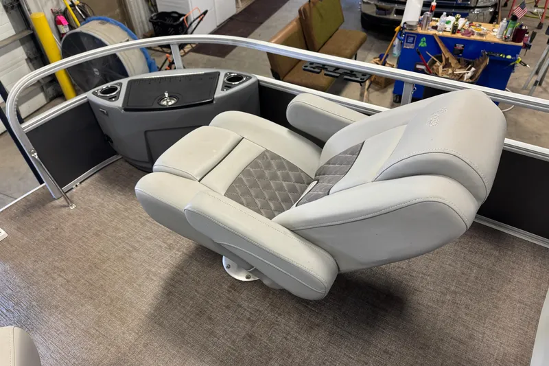 Slide: The Image of 2023 Ranger Reata 220F boat seat with gray upholstery and armrests in a workshop setting. - 10