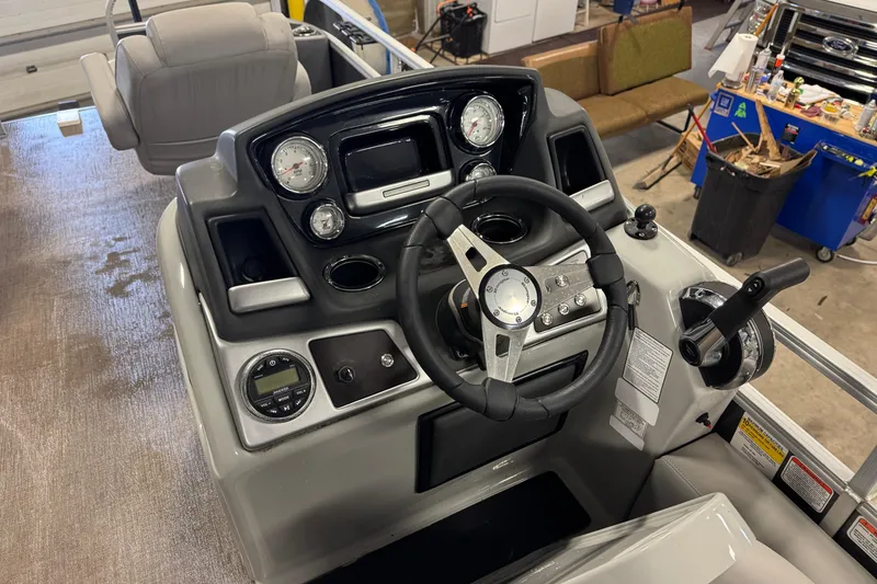 Slide: The Image of 2023 Ranger Reata 220F boat dashboard with steering wheel and control panel. - 12