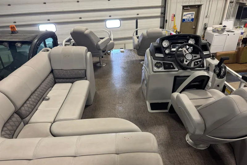 Slide: The Image of 2023 Ranger Reata 220F boat interior with plush seating and modern dashboard. - 8