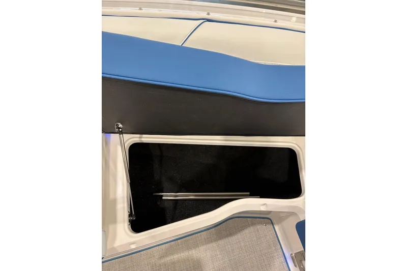 Slide: The Image of 2026 Regal LS6 Surf boat storage compartment with blue and black seating. - 13