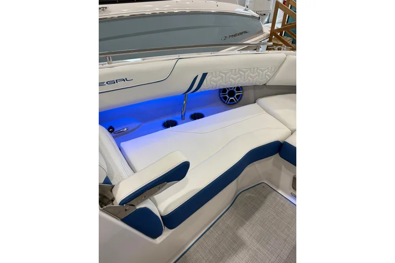 Slide: The Image of 2026 Regal LS6 Surf boat interior with blue LED lighting and white cushioned seating. - 14