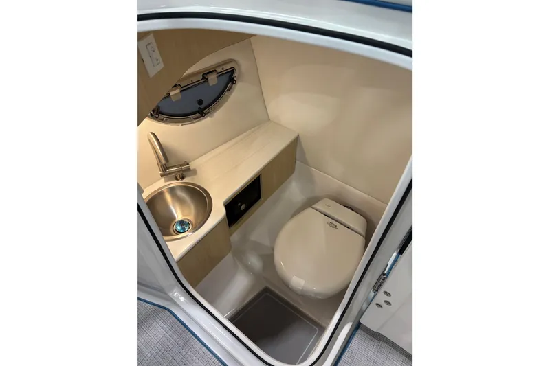 Slide: The Image of Compact bathroom in 2026 Regal LS6 Surf boat with sink and toilet. - 18