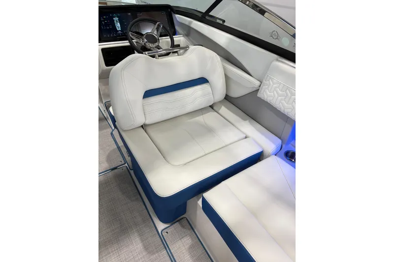 Slide: The Image of 2026 Regal LS6 Surf boat interior with white and blue seating, modern dashboard. - 20