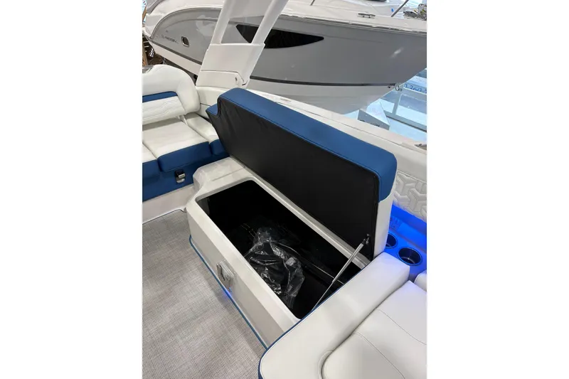 Slide: The Image of 2026 Regal LS6 Surf boat interior with open storage compartment and blue accents. - 23