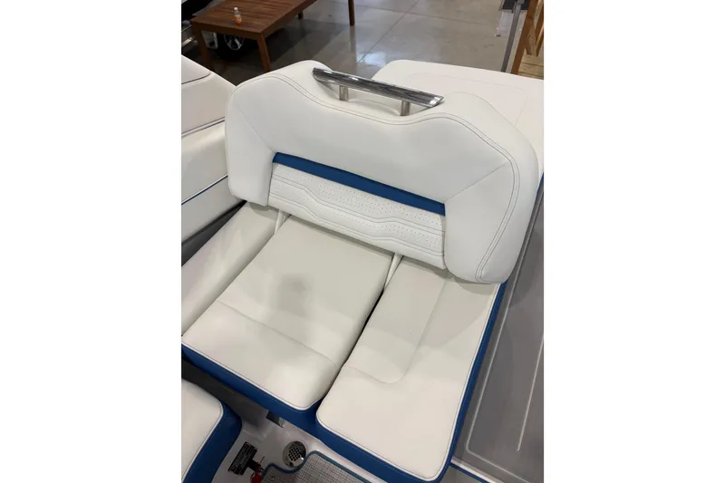 Slide: The Image of White leather seat of 2026 Regal LS6 Surf boat with blue accents. - 26