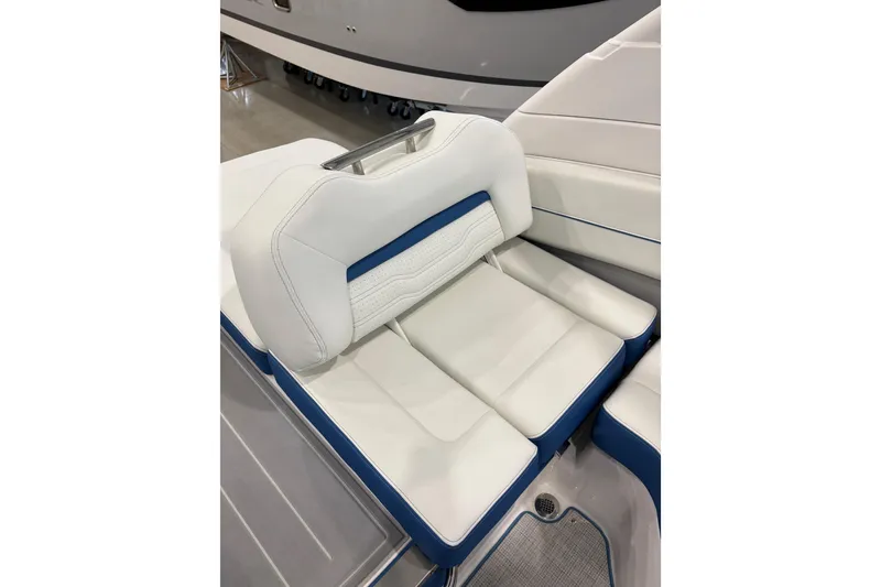 Slide: The Image of 2026 Regal LS6 Surf boat interior with white and blue cushioned seating. - 28