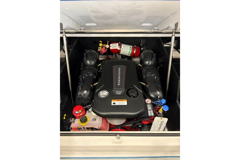 Slide: The Image of 2026 Regal LS6 Surf engine compartment with Volvo Penta V6, featuring fire extinguisher. - 29