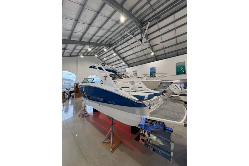 Slide: The Image of 2026 Regal LS6 Surf boat displayed in a showroom with modern interior. - 3