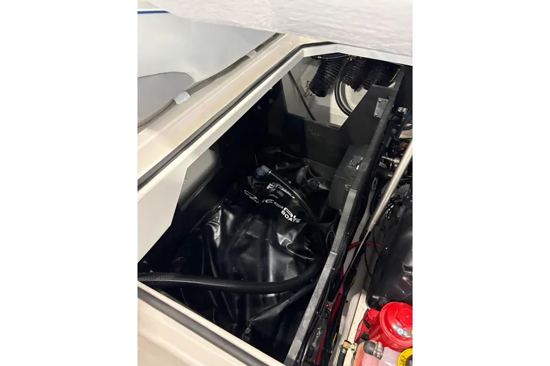 Slide: The Image of 2026 Regal LS6 Surf boat engine compartment with visible components and wiring. - 30