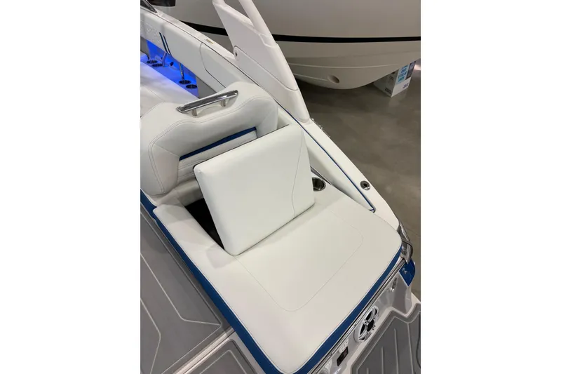 Slide: The Image of 2026 Regal LS6 Surf boat interior with white cushioned seating and blue accents. - 33