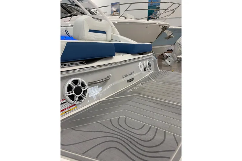 Slide: The Image of 2026 Regal LS6 Surf boat with sleek design and modern features in showroom. - 36