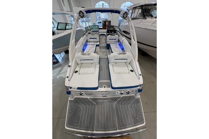 Slide: The Image of 2026 Regal LS6 Surf boat with sleek interior and modern design in showroom. - 7