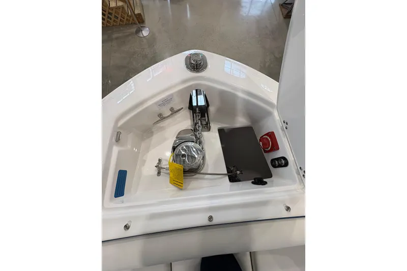 Slide: The Image of 2026 Regal LS6 Surf boat anchor compartment with winch and controls. - 9