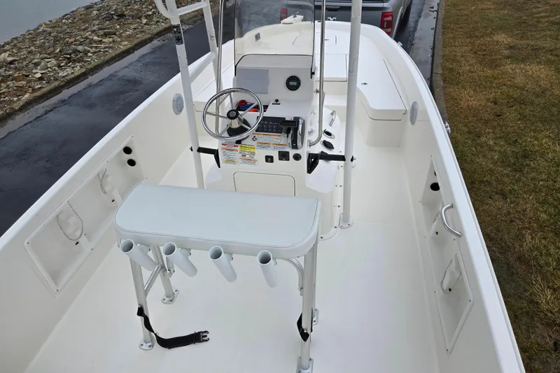 Slide: The Image of 2022 Bayliner Trophy T21Bay boat interior with steering console and rod holders. - 10