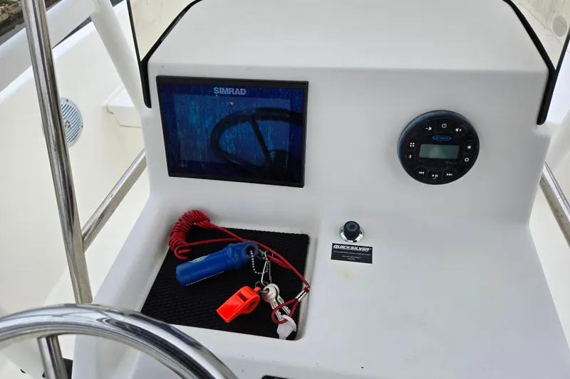 Slide: The Image of 2022 Bayliner Trophy T21Bay dashboard with Simrad display and safety equipment. - 12