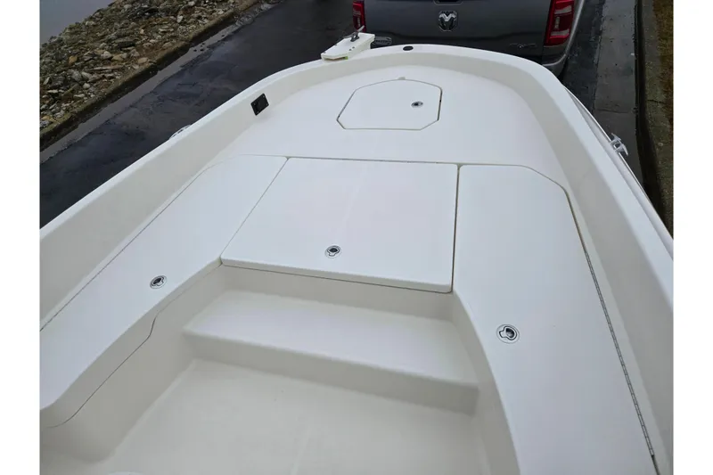 Slide: The Image of 2022 Bayliner Trophy T21Bay boat deck, featuring spacious seating and storage compartments. - 16