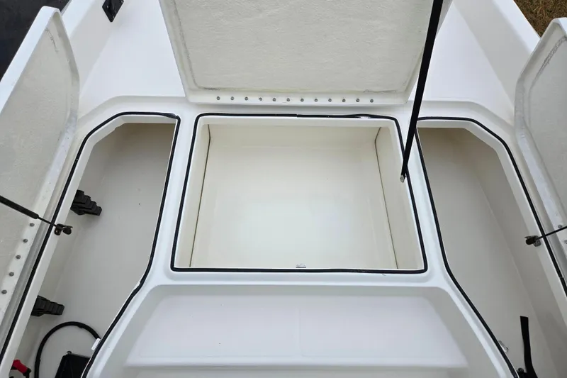Slide: The Image of 2022 Bayliner Trophy T21Bay storage compartments with open hatches, showcasing spacious interior design. - 17