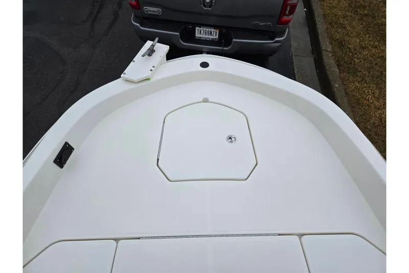 Slide: The Image of 2022 Bayliner Trophy T21Bay boat bow, parked near a truck. - 18