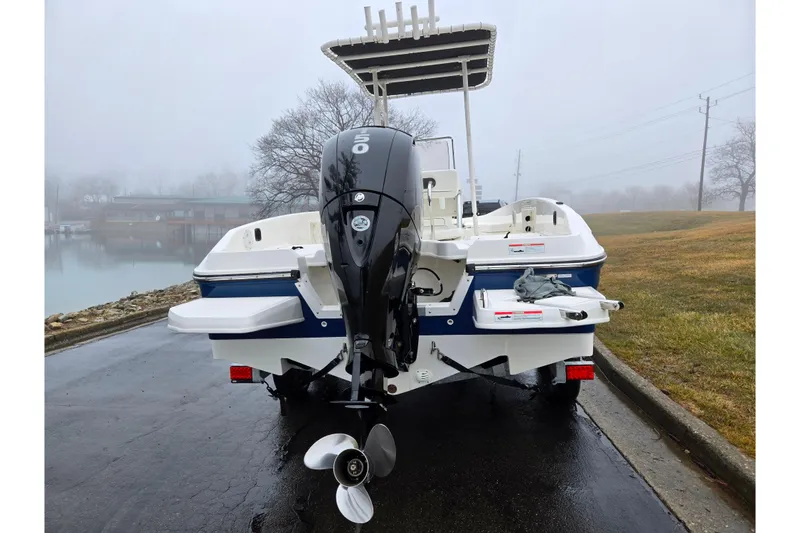 Slide: The Image of 2022 Bayliner Trophy T21Bay boat with outboard motor on a foggy day. - 2
