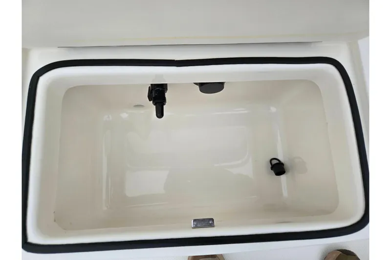 Slide: The Image of 2022 Bayliner Trophy T21Bay livewell interior with black trim and fittings. - 23