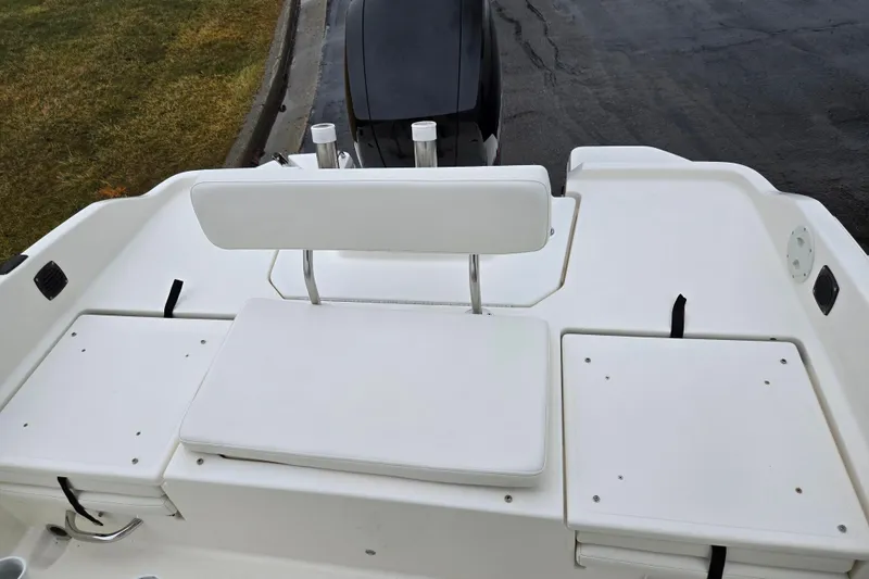 Slide: The Image of 2022 Bayliner Trophy T21Bay boat with white seating and storage compartments. - 26