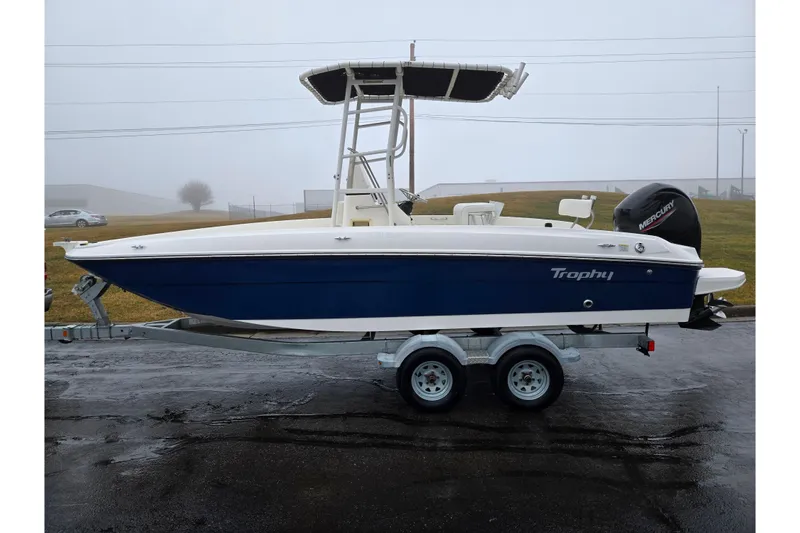 Slide: The Image of 2022 Bayliner Trophy T21Bay boat on trailer, side view in foggy setting. - 4